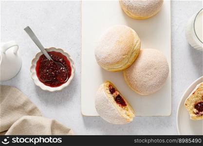 Berliner donut. Traditional german donut with raspberry jam, dusted with icing sugar. Top view