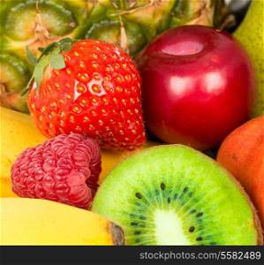 Berries and fruit closeup. Strawberries and kiwi, plum and raspberry closeup background.
