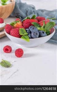 Berries for healthy breakfast. Bowl of raspberry, blueberries and strawberries