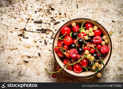 Berries in a Cup. On the rustic background.. Berries in a Cup. On rustic background.