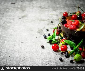 Berries in a Cup. On the stone table.. Berries in a Cup. On stone table.