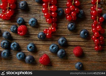 Berries mix on wooden board blueberries red currants and raspberries