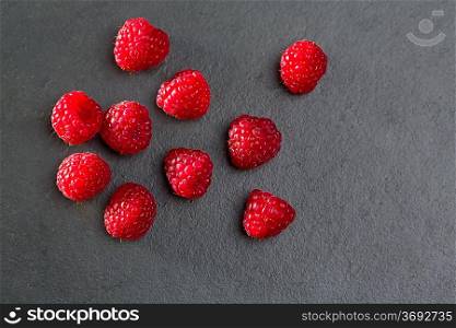 berries raspberry on black slate background macro closeup