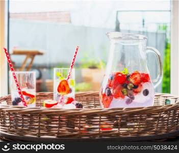 Berries Water, beverage in glass jug, front view