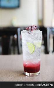 Berry cocktail with lime on wood background