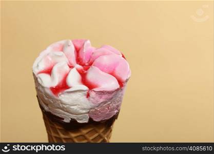 Berry frozen icecream waffle cone on orange. Refreshing dessert for summertime