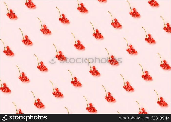 Berry pattern. Twigs of red currant berry on pink paper background. Minimal style Creative Flat lay Top view.. Berry pattern. Twigs of red currant berry on pink paper background. Minimal style Creative Flat lay Top view