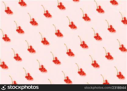 Berry pattern. Twigs of red currant berry on pink paper background. Minimal style Creative Flat lay Top view.. Berry pattern. Twigs of red currant berry on pink paper background. Minimal style Creative Flat lay Top view