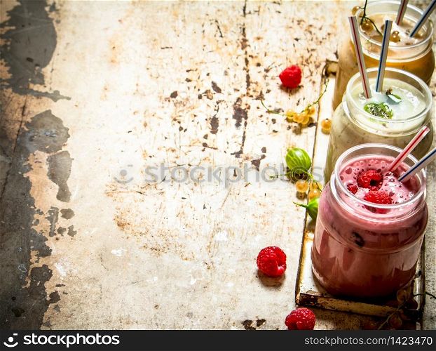 Berry smoothie gooseberries, raspberries and white currants. On rustic background.. Berry smoothie gooseberries, raspberries and white currants.