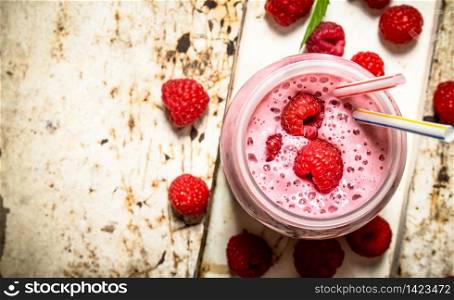 Berry smoothie made from wild raspberries. On rustic background.. Berry smoothie made from wild raspberries.