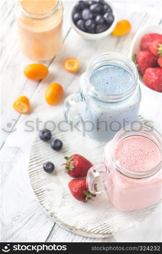 Berry smoothies on the wooden board
