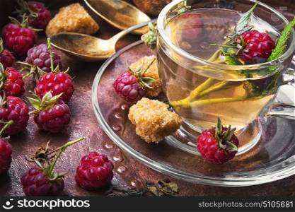 Berry tea with raspberries. Herbal medicinal tea with ripe fresh raspberry berries