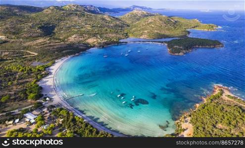 Best beaches of Corsica island - aerial panoramic view of beautiful Rondinara beach with perfect round shape and crystal turquoise sea.
