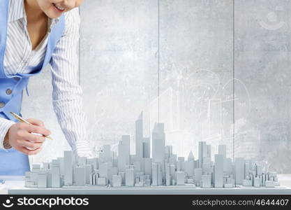 Best development project. Close view of businesswoman signing construction project documents