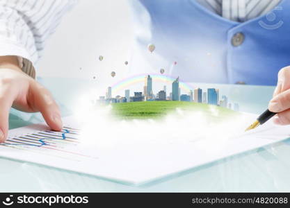 Best development project. Close view of businesswoman signing construction project documents