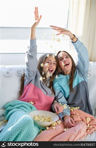 best friend girls at sofa having fun with popcorn. best friend girls at sofa having fun with popcorn watching movie