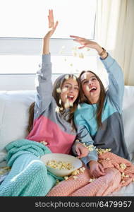best friend girls at sofa having fun with popcorn. best friend girls at sofa having fun with popcorn watching movie