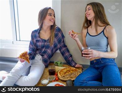 best friend girls eating pizza in the kitchen. best friend teen girls eating pizza in the kitchen at lunch having fun