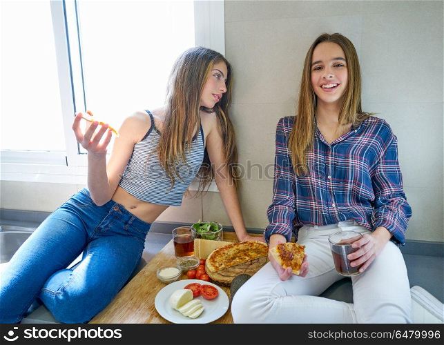 best friend girls eating pizza in the kitchen. best friend teen girls eating pizza in the kitchen at lunch having fun