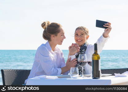 Best friends celebrating on the beach and make a selfie. Celebration concept.. Best friends make a selfie