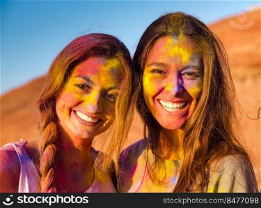 Best friends full of colored powder all over the body