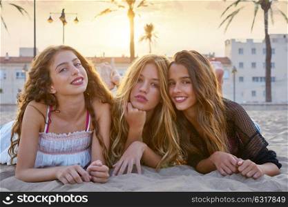 Best friends girls at sunset beach sand smiling happy together