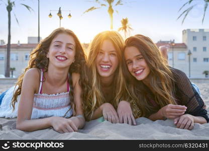 Best friends girls at sunset beach sand smiling happy together