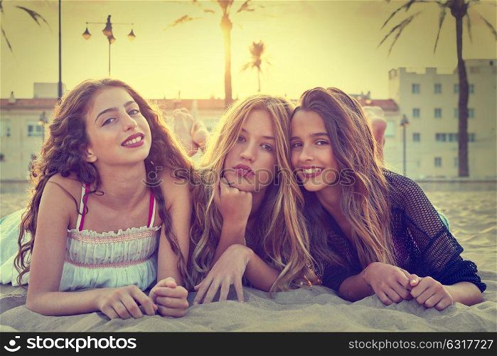 Best friends girls at sunset beach sand smiling happy together filtered image