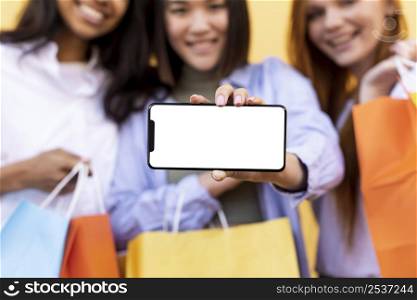 best friends holding shopping bags blank phone