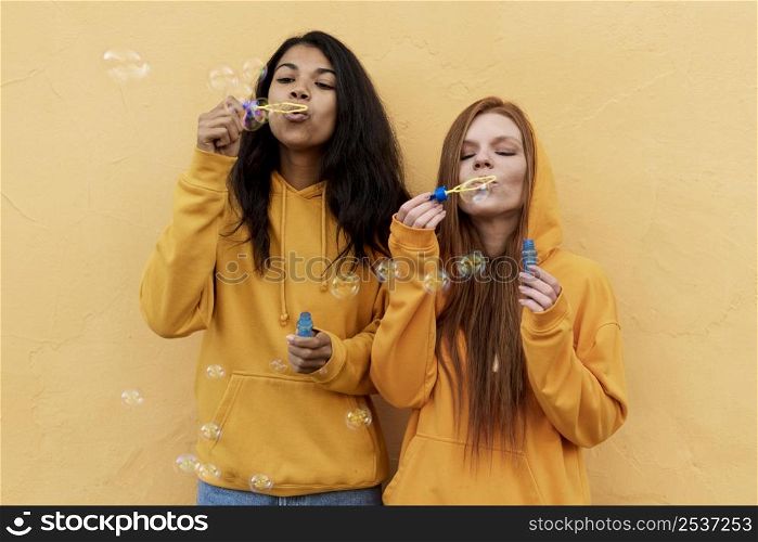 best friends making soap bubbles