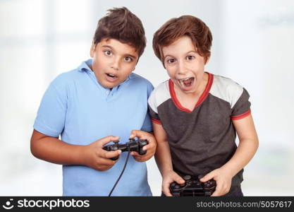 Best friends playing on playstation at home, crazy emotion of video games, two excited teen boys enjoying competition, winner and loser in the round