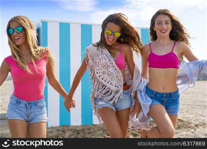 Best friends teen girls group running happy in a beach having fun