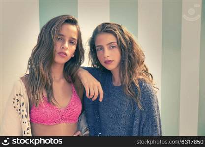 Best friends teen girls portrait in a summer blue stripes background filtered image
