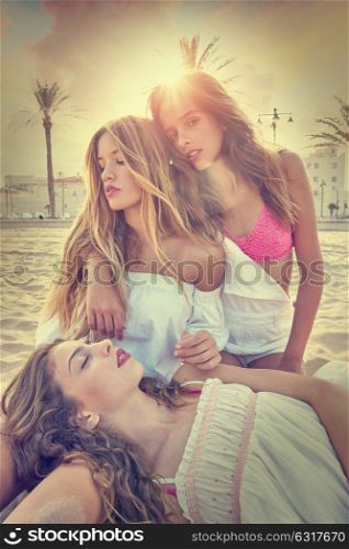 Best friends teen girls together relaxed on a beach sand at sunset