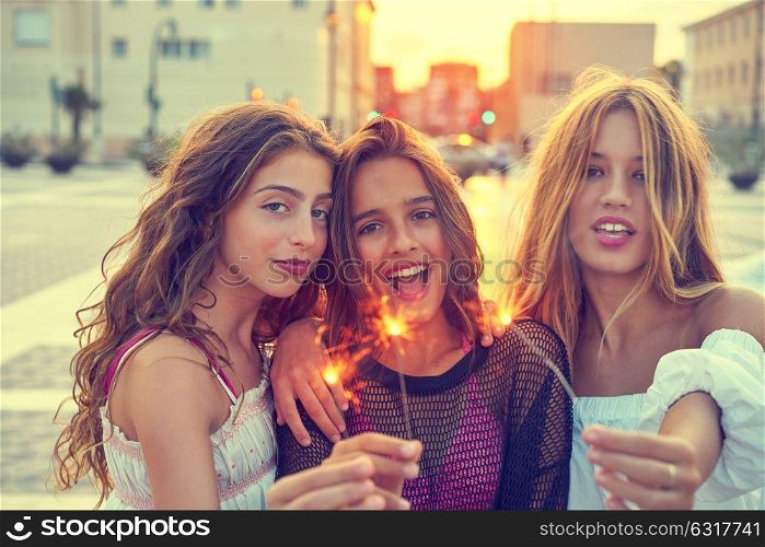 Best friends teen girls with sparklers at sunset in the city