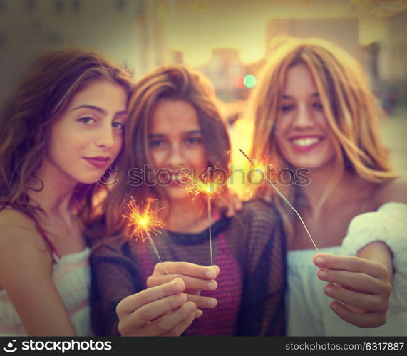 Best friends teen girls with sparklers at sunset in the city filtered image