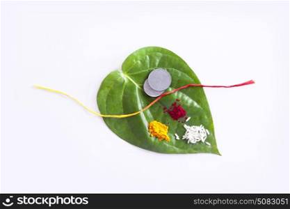 Betel Leaf with Rice,Coins,Red thread,Kumkum and Turmeric