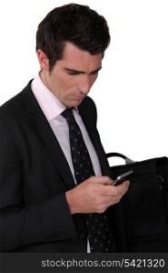 Bewildered businessman reading a text message