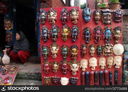 BHAKTAPUR, NEPAL - CIRCA NOVEMBER 2013 Woman sell wooden masks for tourists in Nepal