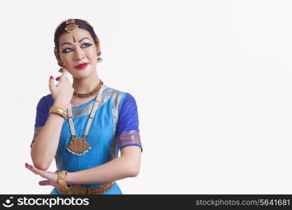 Bharata Natyam dancer performing over white background