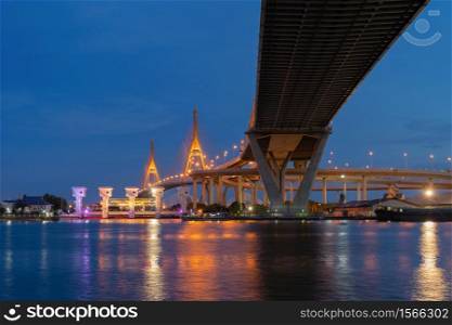 Bhumibol Bridge and Chao Phraya River in structure of suspension architecture concept, Urban city, Bangkok. Downtown area at night, Thailand.