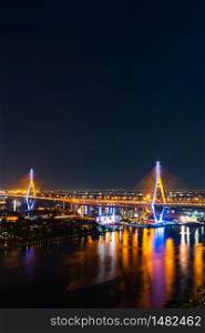 Bhumibol suspension bridge cross over Chao Phraya River at night in Bangkok city, Thailand