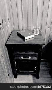 bible on bed side table in cheap hotel room