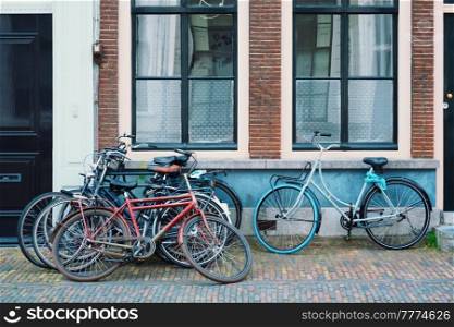 Bicecles which are a very popular transport in Netherlands parked in street near old houses. Utrecht, Netherlands. Bicecles which are a very popular transport in Netherlands parked in street near old houses
