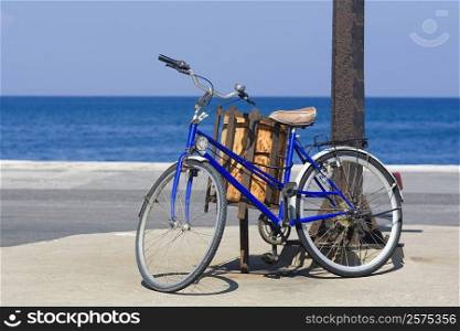 Bicycle by a pole on the beach, Rhodes, Dodecanese Islands, Greece