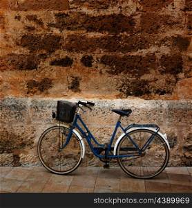 Bicycle in historical Ciutadella stone wall at Balearic islands