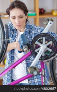 bicycle mechanic repairing a bike in workshop