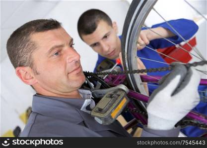 bicycle mechanic working in his bike workshop