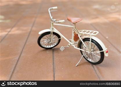 bicycle model on wood floor - travel and journey concept