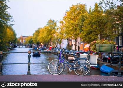 Bicycle on the bridge in Amsterdam Netherlands. Bikes on the bridge in Amsterdam, Netherlands. Beautiful view of canals in autumn
